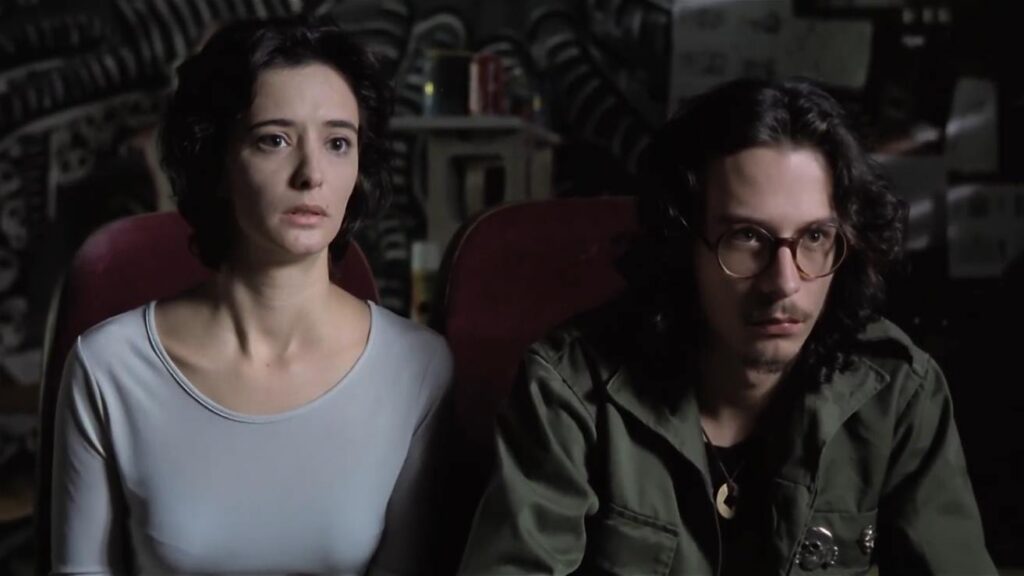 Angela and Chema, main characters of the movie watching a violent video